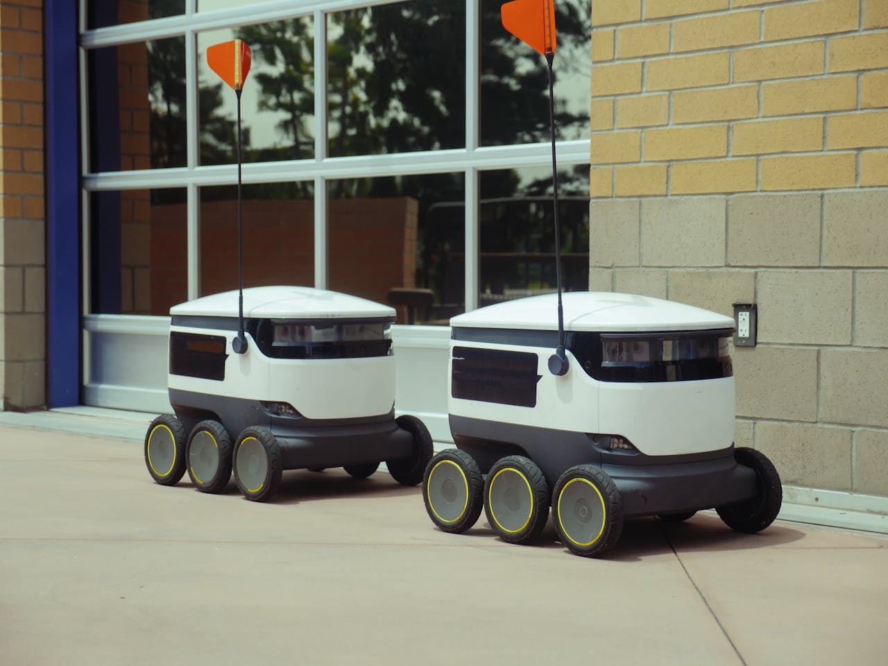 services-03 Futuristic autonomous robots designed for efficient outdoor food delivery.